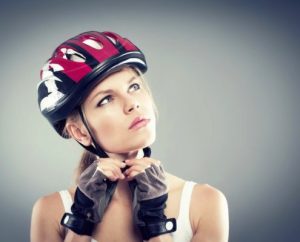 Cycling. Female putting biking helmet before ride.